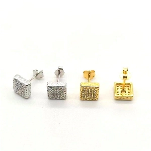 Macro shot of silver and gold square stud earrings with pave-set cubic zirconia stones