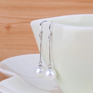 Elegant s925 silver long drop earrings with white natural shell pearls hanging on a cup