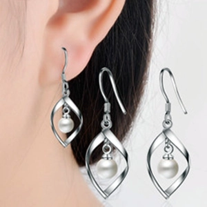 Elegant s925 silver pearl drop earrings with hollow twist design shown on a model