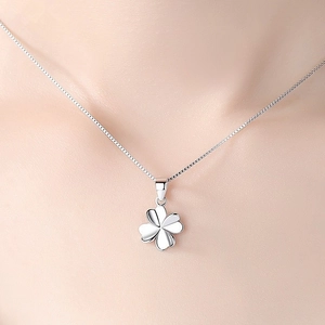 Elegant S925 sterling silver four-leaf clover necklace with polished finish on model
