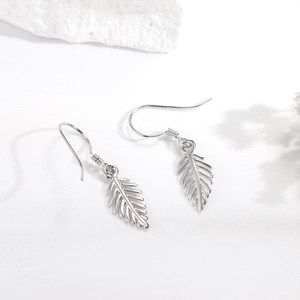 Detail shot of S925 sterling silver feather earrings showing clear texture and hallmarks