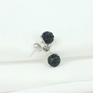 Macro shot of 925 silver stud earrings featuring black pave crystal disco balls