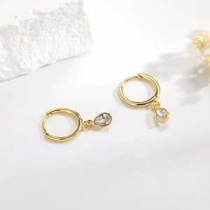 925 silver hoop earrings with water drop zircon pendants on a white minimalist stone