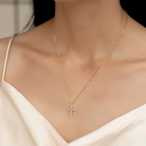 Elegant gold cross pendant necklace with sparkling pave zircons on a delicate chain