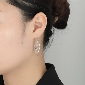 Macro detail of S925 sterling silver triple-layer leaf-shaped wavy drop earrings