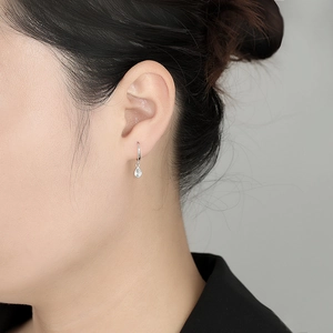 S925 sterling silver hoop earrings with pear-shaped teardrop crystal on female model
