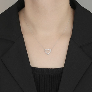 Close-up of S925 sterling silver hollow heart pendant necklace with shimmering crystals