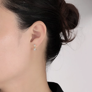 Minimalist S925 sterling silver bow earrings with sparkling cubic zirconia on model