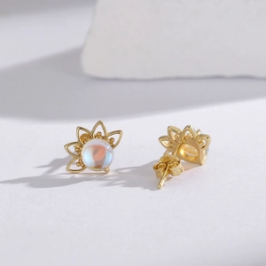 Asymmetric moonstone sun flower stud earrings in gold finish with blue iridescent opal