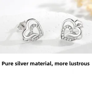 Detail view of 925 sterling silver heart earrings with micro-set cubic zirconia accents