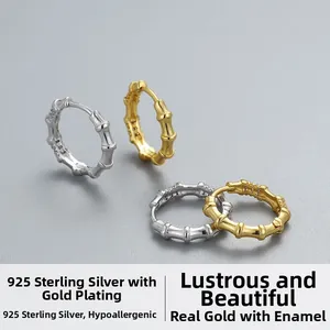 Macro shot of bamboo-shaped S925 sterling silver hoop earrings with a polished gold finish