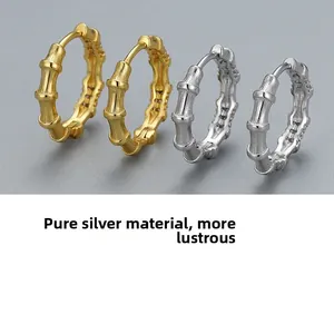 Detailed close-up of gold and silver S925 sterling silver bamboo textured hoop earrings