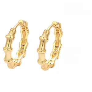 Macro shot of gold bamboo-shaped S925 sterling silver hoop earrings with a shiny finish
