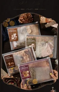 Macro view of vintage collage kit with pearls, lace and antique style paper stickers