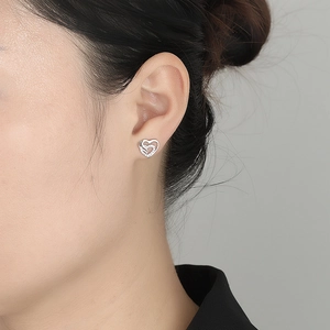 925 silver double heart stud earrings with cubic zirconia on female model closeup