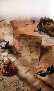 Macro view of vintage style scrapbook papers with old newspaper textures and art prints