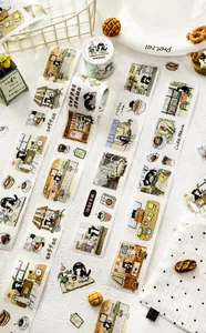 Close-up of cat cafe themed washi tape with cute barista cats and dessert illustrations