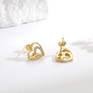 Elegant 925 sterling silver double heart stud earrings with sparkling crystals in gold finish