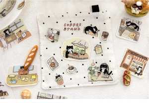 Close-up of cat cafe themed cotton linen coaster with black polka dots and hanging loop