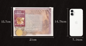 Detail of vintage scrapbooking kit showing lace, faux pearls and size comparison to a phone
