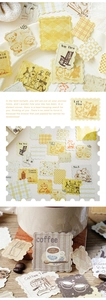 Macro detail of warm yellow dog stamps and vintage collage stickers for scrapbooking