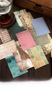 Macro detail of vintage scrapbook stickers with floral bills and antique maps on wood