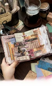 Close-up of vintage aesthetic scrapbook with retro labels, butterflies and lace details