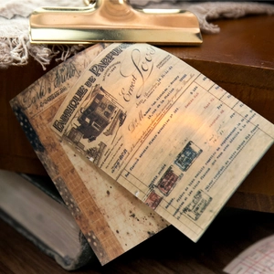 Vintage French perfume bill style decorative paper with gold clip and antique book