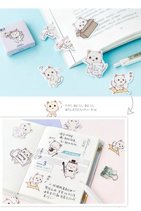 Detail of cute cat stickers on a planner with blue and white themed stationery