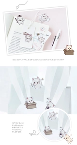 Detail of cute cartoon cat stickers decorating a notebook and paper gift bag