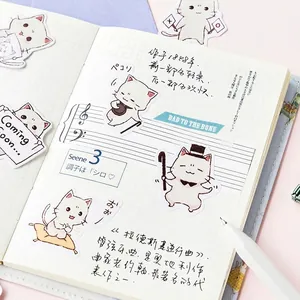 Cute white cat decorative stickers set for DIY scrapbooking and planners on a desk