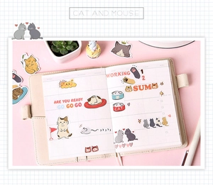 Cat and mouse themed hand-drawn stickers on a beige loose-leaf planner diary