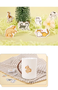 Detailed view of cartoon pet stickers applied on a mug for creative DIY journaling