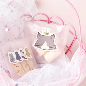 Cute cat stickers on translucent snack bags in pink basket with star mesh background