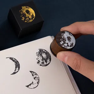 Retro moon phase wooden stamp with round lunar surface pattern and black gift box