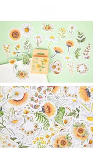 Macro detail of daisy and sunflower stickers with yellow box for scrapbook decor