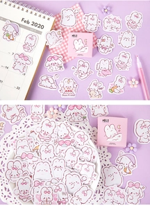 Detail shot of cute Pupu Rabbit cartoon stickers in a pink box with creative stationery props
