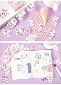 Detailed view of cute rabbit stationery stickers on a notebook with pink floral decor