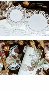 Macro view of white lace hollow paper stickers with vintage Victorian butterfly patterns