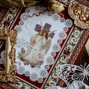 Vintage renaissance style white lace decorative paper featuring angel theme and floral motifs