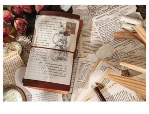 Detail of vintage traveler's notebook with leather cover and Alice themed scrapbook papers