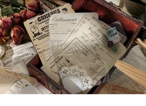 Close-up of vintage aesthetic scrapbook paper set inside a rustic wooden storage box