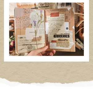 Detail of vintage scrapbook paper featuring real dried purple flowers and retro textures