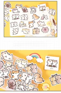 Close-up of cute cartoon cat stickers for scrapbooking and journal decoration in a box