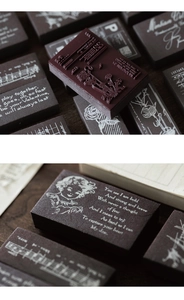Macro detail of vintage wooden stamps featuring retro character designs and musical scores