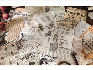 Flat lay of vintage scrapbooking paper with antique advertisements on dark wood background