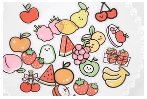 Detail of transparent cartoon fruit stickers featuring cute expressions for journals