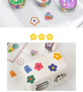 Detail of colorful hand-drawn cartoon washi tape with floral and bear patterns for journaling