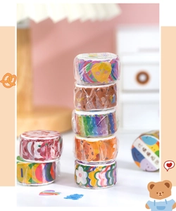 Detailed view of stacked washi tapes featuring cute bear and floral illustrations