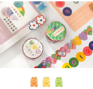 Detail of cute hand-drawn washi tape and stickers with green stripes and bear patterns
